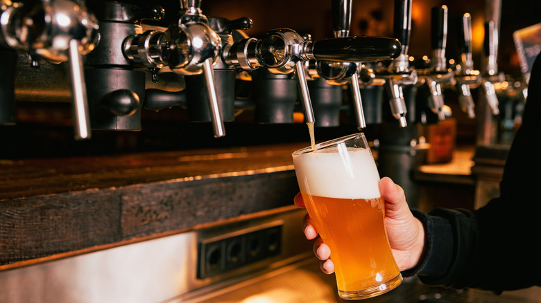 Beer being poured from a tap in a bar