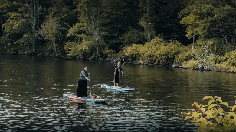 Women stand-up paddleboarding on Swan Lake, NY