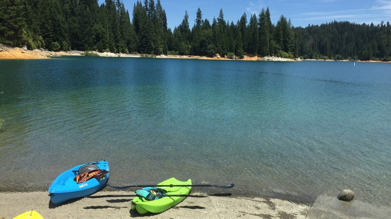 Two kayaks resting on the shore of Sly Creek Reservoir.