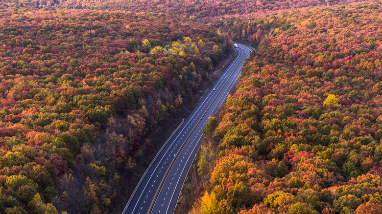 Aerial view of the Lehighton area of Pennsylvania during the fall with a highway going through the middle of a forest.