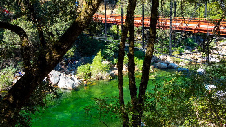 A man wades in the South Yuba River at Purdon Crossing