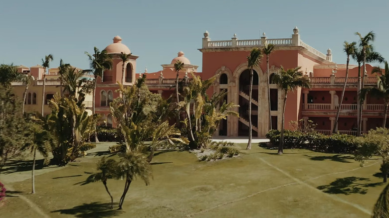 View of Sanctuary Cap Cana main building exterior with palm trees.