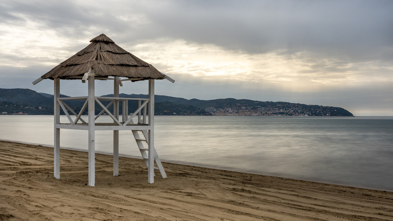 Beach tower overlooking water on cloudy day