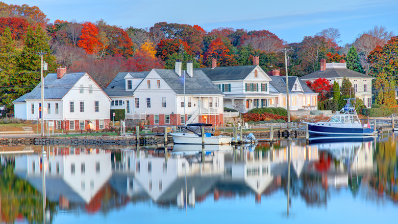 Houses on the shore of Mystic, Connecticut surrounded by fall foliage.