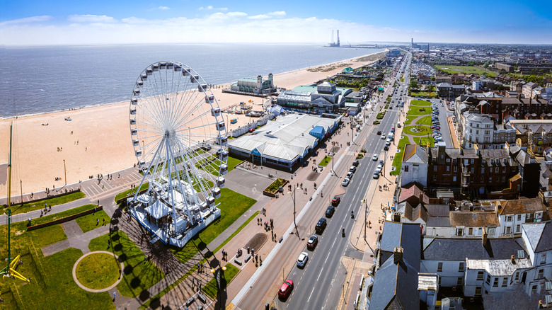 An aerial landscape of Great Yarmouth, UK, with a beach, buildings, and Ferris wheel featured prominently