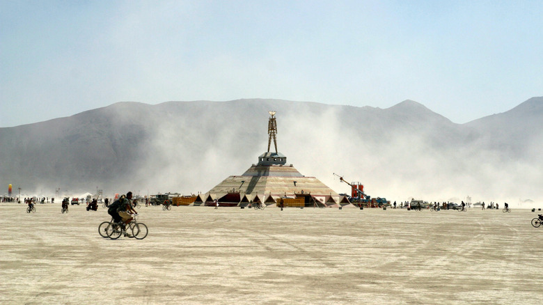 The sculpture of a man rises out of a pyramid at Burning Man festival, in Nevada.