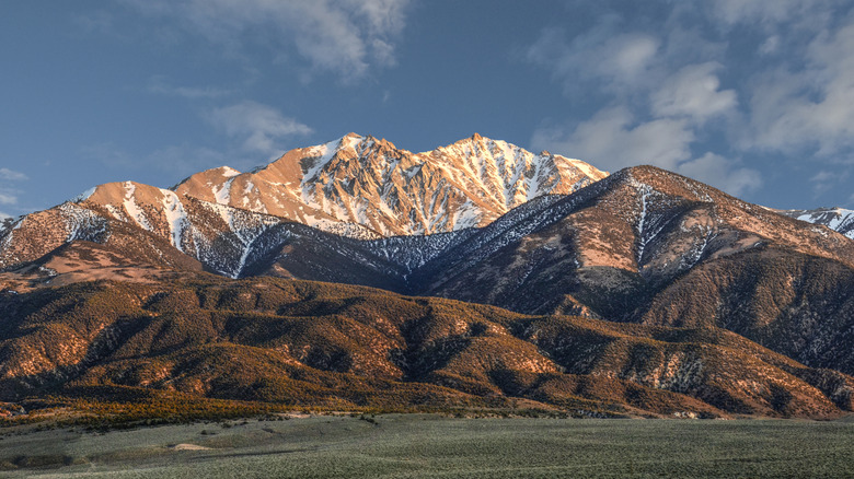 The snow- and tree-covered Boundary Peak with other mountains in Nevada
