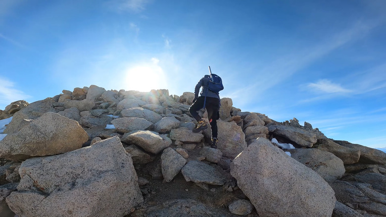 A lone hiker scrambles up the extremely steep rocks on Boundary Peak