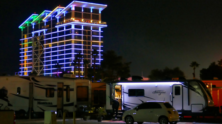 RV parked outside of a neon-lit casino
