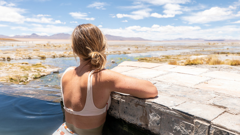 A woman enjoying an outdoor hot spring