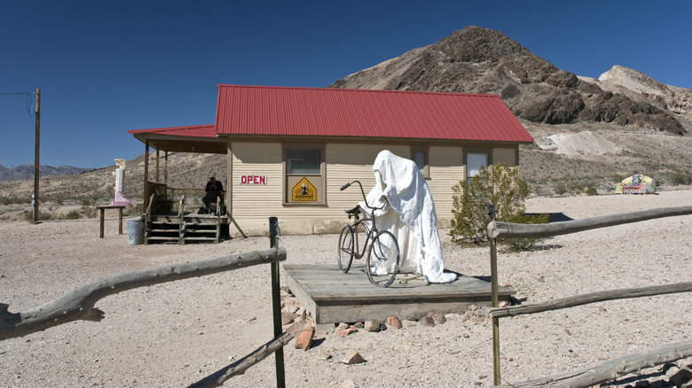 Sculpture in the open air museum leaning over a bike