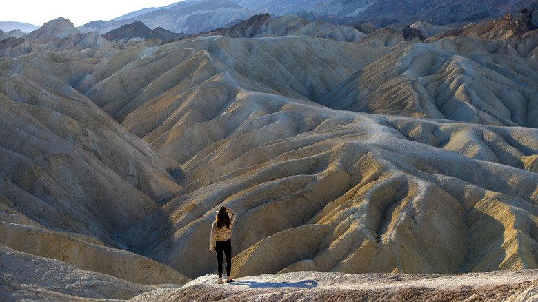 Woman standing among the hills in Death Valley
