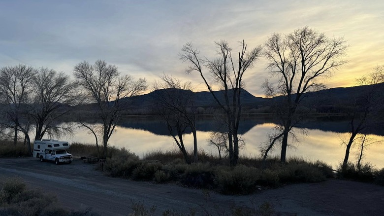 RV camped next to a lake in the wintertime