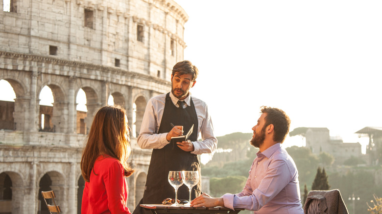 A couple placing and order at a restaurant in Rome