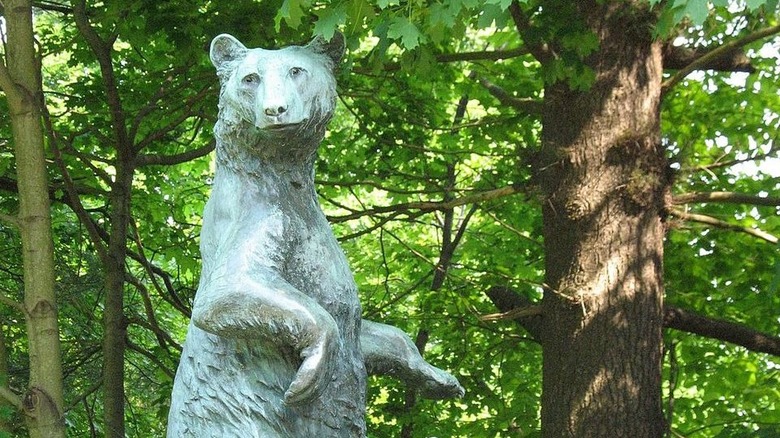 Bear statue surrounded by trees at Collis P. Huntington State Park.