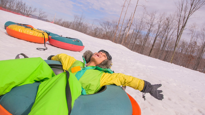 Person enjoying tubing on a hill in New England