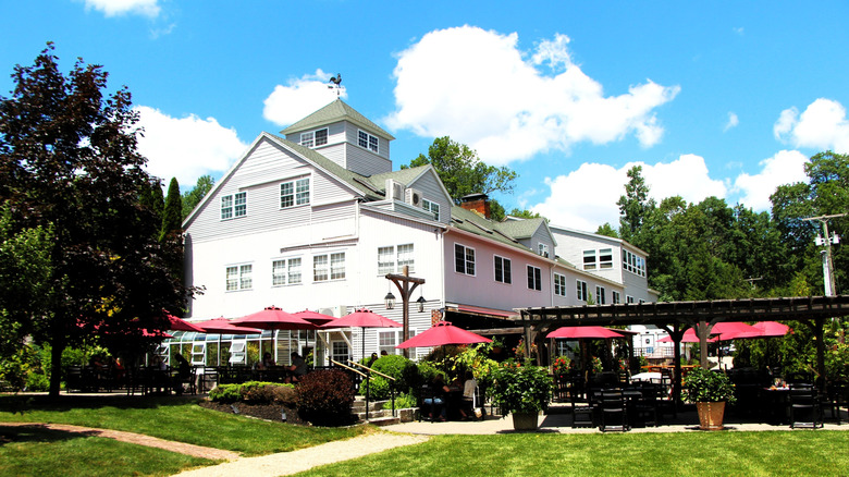 The main house on the Zorvino estate with an outdoor patio and grape vines