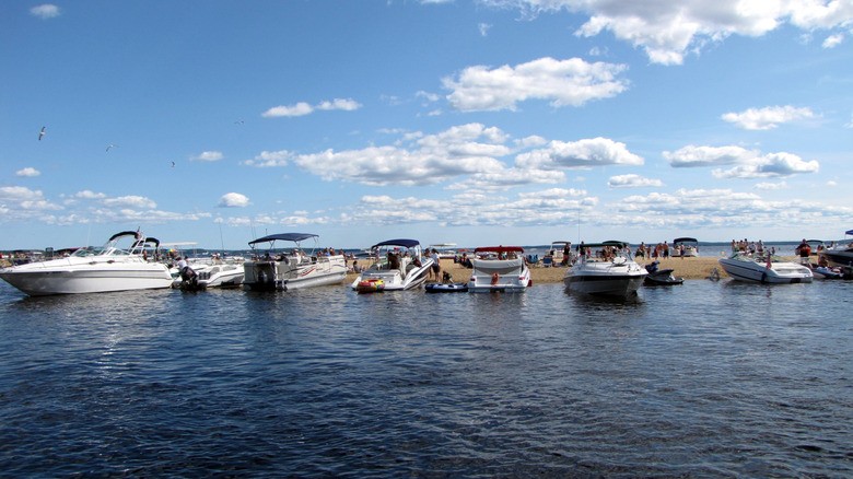 Boats docked at a sandbar in Sebago Lake, Maine