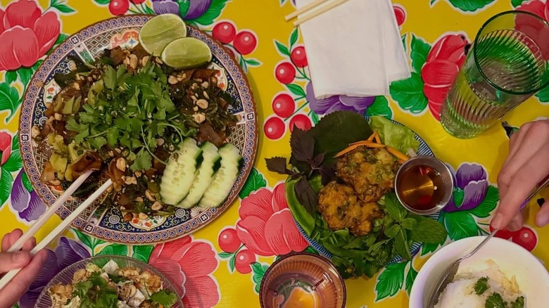 An overhead view of people eating sevral Vietnamese dishes at Công Tử Bột