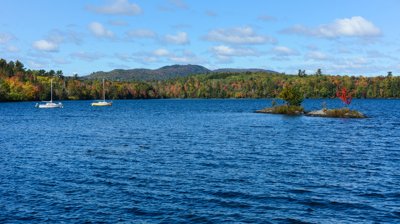 Two boats and fall foliage at Umbagog Lake in Errol, New Hampshire