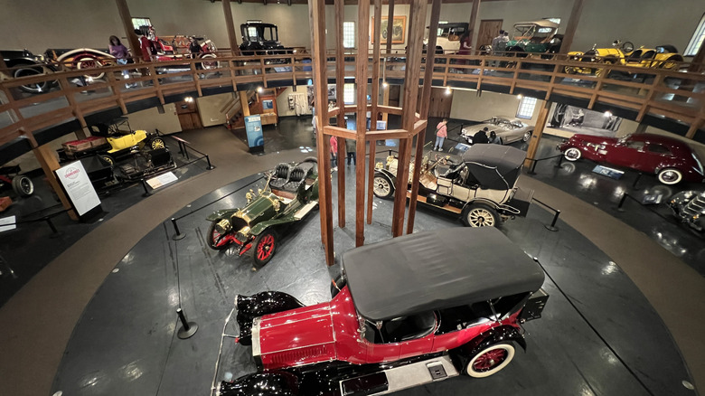 Vintage cars are displayed inside a round museum at Heritage Museums & Gardens in Massachusetts