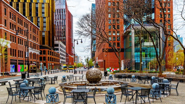Downtown Cambridge, Mass., public square with fountain and patio tables.