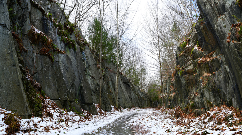 Snowy pathway through cliffs on Northern Rail Trail in New Hampshire