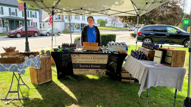 A person selling products at a booth