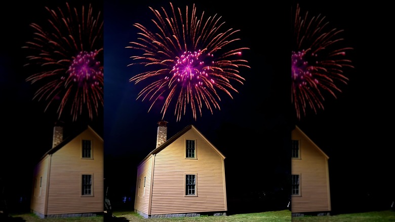 Pink firework exploding over house in Hollis, New Hampshire