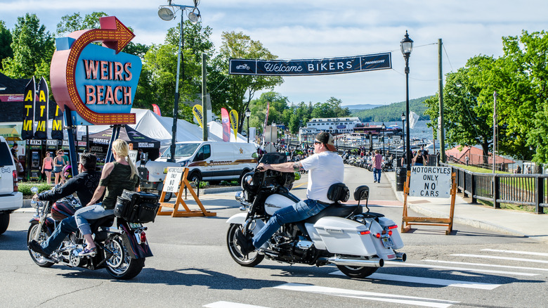 Motorcycles in front of Weirs Beach Sign