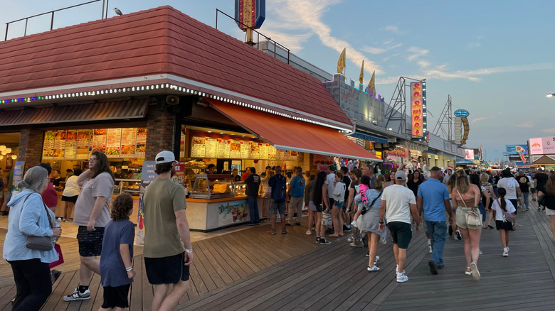 People walking on the boardwalk of Wildwood New Jersey, on the Jersey Shore, near the diners and pizzerias