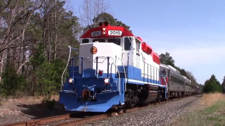 The Seashore Line traveling  with trees in the background