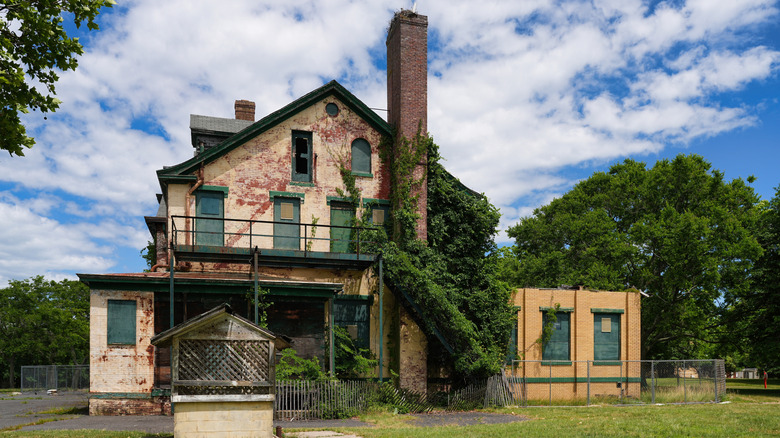Abandoned Officer's Club at Fort Hancock, a brick building with peeling white paint