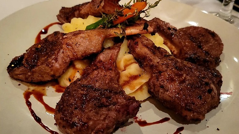 A five lamb cutlets on top of mashed potato served on a plate at Chubby's Steakhouse & Seafood