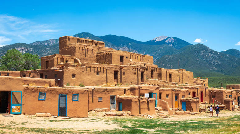 Historic Taos pueblo with mountains in background