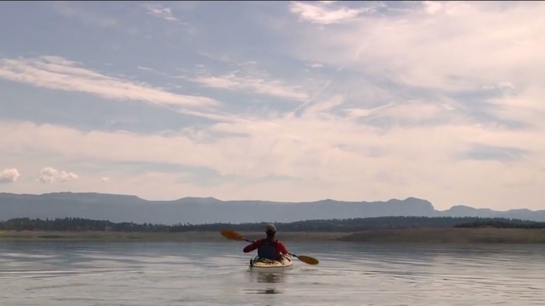Kayaker paddling on Heron Lake State Park in New Mexico