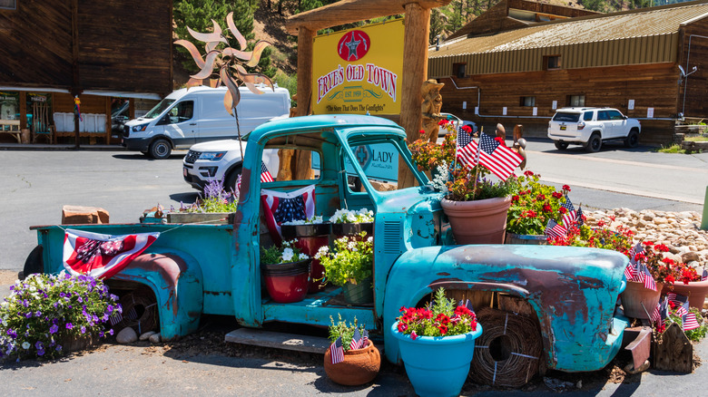 A vintage truck filled with flowers and flags in Red River, New Mexico