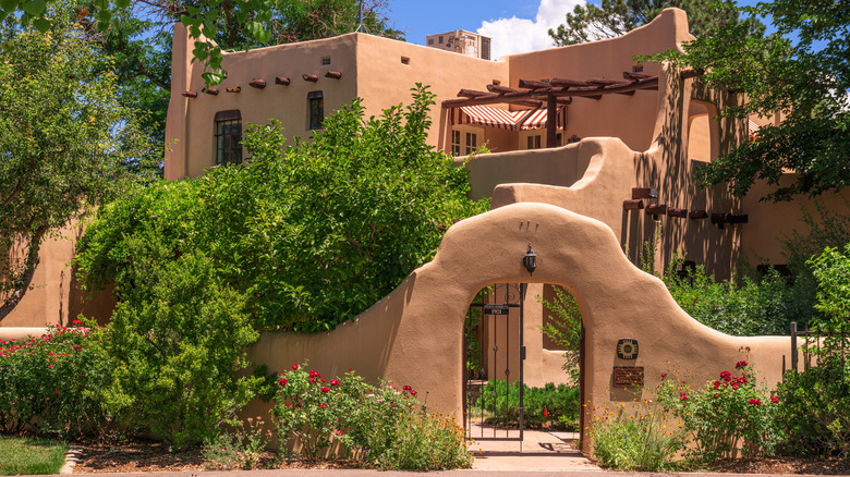 Classic Pueblo-revival house covered with lush vegetation, Albuquerque