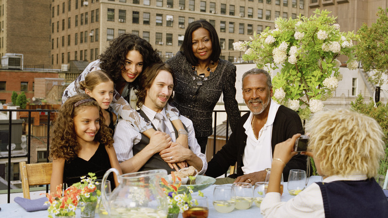 A family taking photos at a rooftop party in New York City