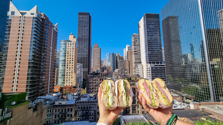 Bagel sandwhiches in front of a view of the NYC skyline