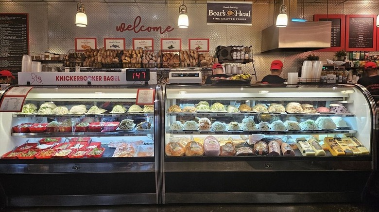 Inside of Knickerbocker Bagel, NYC with fridge full of cream cheese spreads