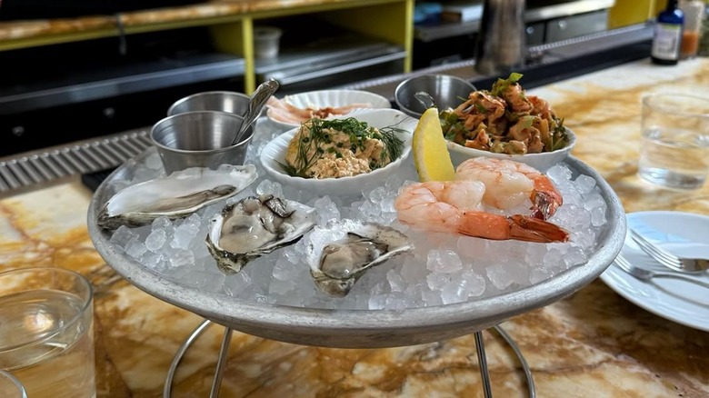 Oysters, shrimp, and other raw bar items served on ice at Strange Delight