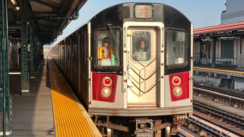 An MTA train pulls into a station in Queens