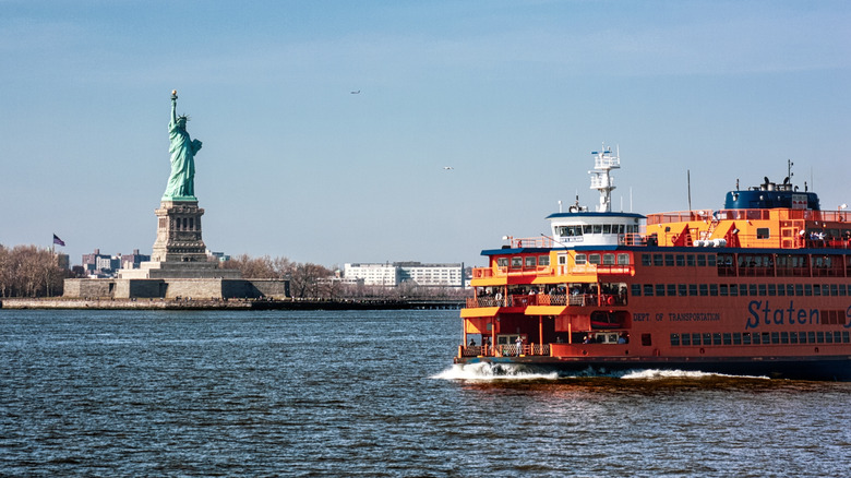 The Staten Island Ferry passes by the Statue of Liberty