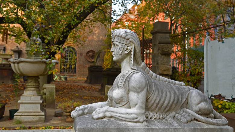 A sphynx statue at Elizabeth Street Garden in the fall