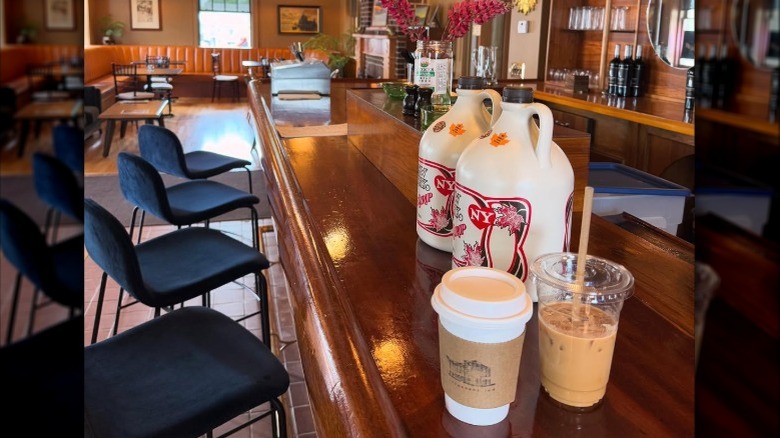 The inside of the Sherburne Inn, showing coffee drinks and maple syrup on a bar