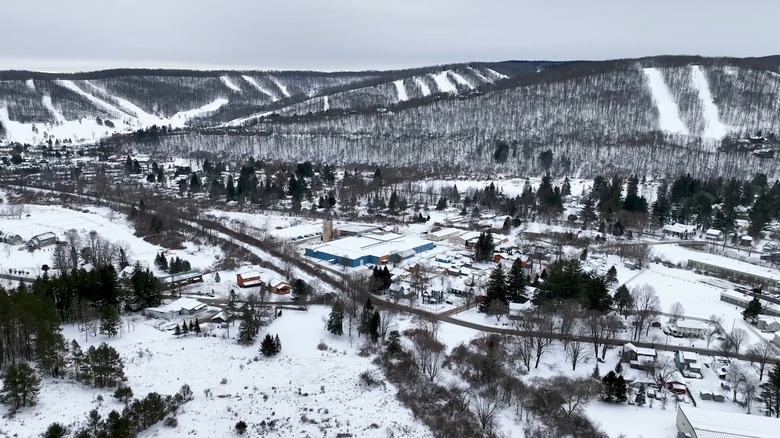 Town of Ellicottville in front of mountains with ski slopes