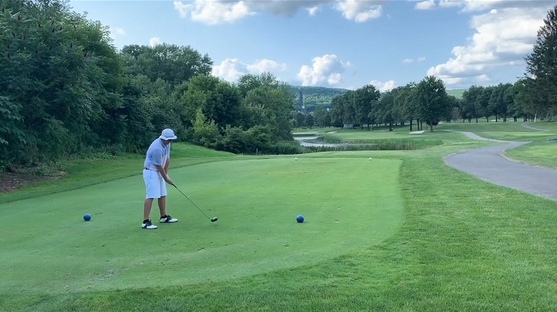 Man teeing off at En-Joie Gold Course