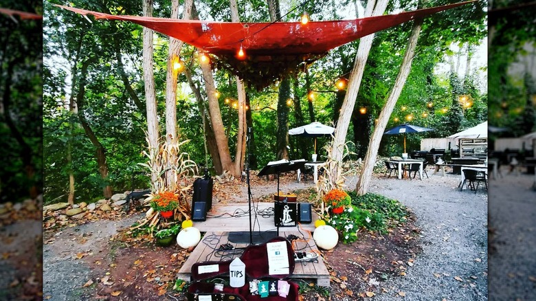 The wooded backyard with a live music setup at Water Side Wine Bar in Phelps, New York.