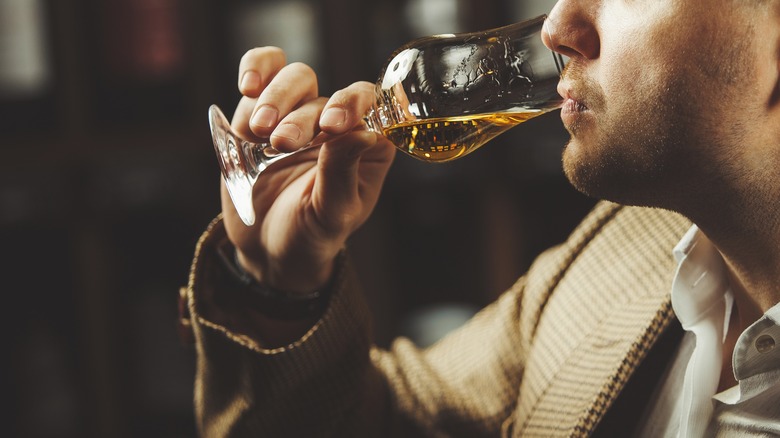 Distillery visitor sipping on whiskey